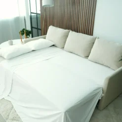 Sofá cama com chaise longue reversível, arrumação e almofadas decorativas